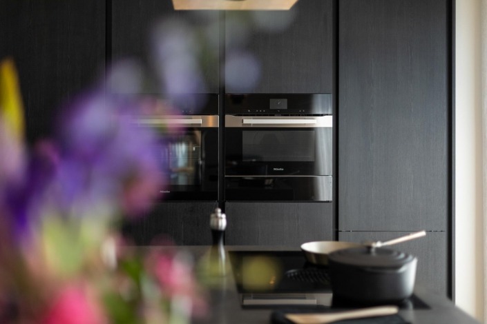 Zwarte stoere SieMatic keuken met ingebouwde apparatenwand en wijnkast